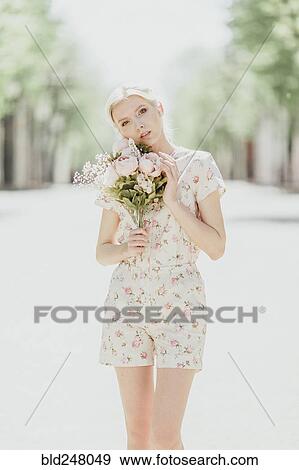 Portrait of Middle Eastern woman holding bouquet View Large Photo Image Stock Photo - Portrait of Middle Eastern woman holding bouquet. Fotosearch