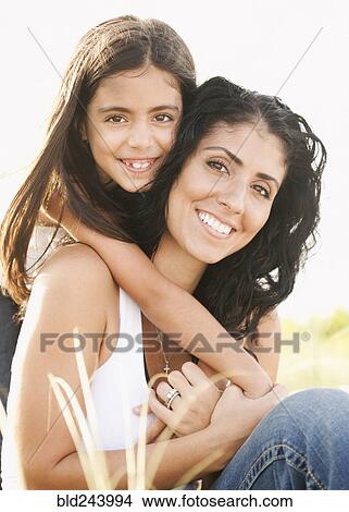 Portrait of Mixed Race girl hugging mother outdoors View Large Photo Image Picture - Portrait of Mixed Race girl hugging mother outdoors. Fotosearch