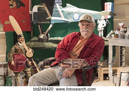 Portrait of older Caucasian man sitting in workshop View Large Photo Image Stock Image - Portrait of older Caucasian man sitting in workshop. Fotosearch
