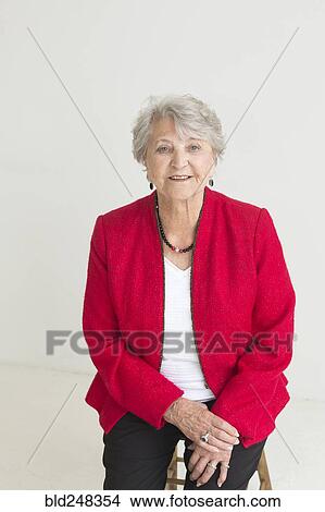 Portrait of older Caucasian woman sitting on stool View Large Photo Image Picture - Portrait of older Caucasian woman sitting on stool. Fotosearch