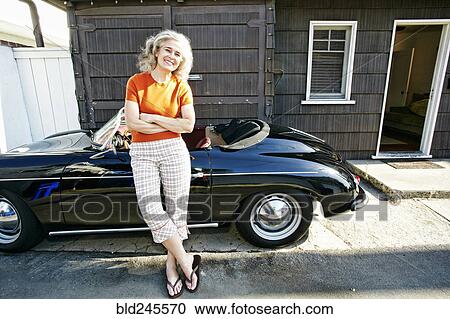 Portrait of older Caucasian woman leaning on convertible car View Large Photo Image Stock Image - Portrait of older Caucasian woman leaning on convertible car. Fotosearch