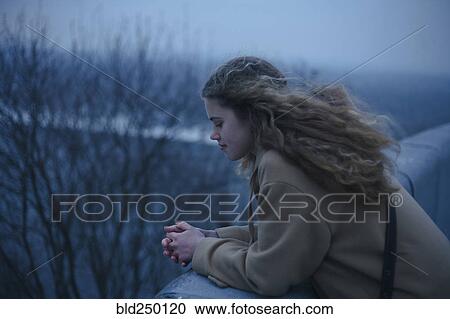 Portrait of pensive Caucasian teenage girl leaning on rooftop View Large Photo Image Stock Image - Portrait of pensive Caucasian teenage girl leaning on rooftop. Fotosearch