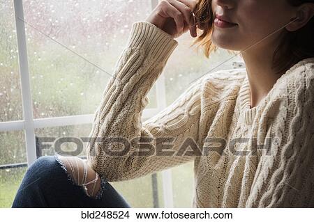 Portrait of pensive Caucasian woman near rainy window View Large Photo Image Picture - Portrait of pensive Caucasian woman near rainy window. Fotosearch