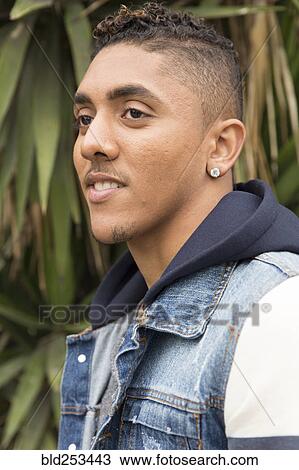 Stock Image - Portrait of pensive Mixed Race man. Fotosearch