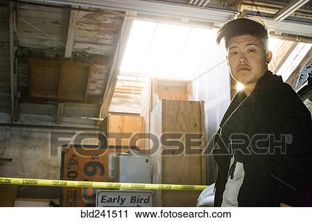 Stock Image - Portrait of serious androgynous Asian man. Fotosearch