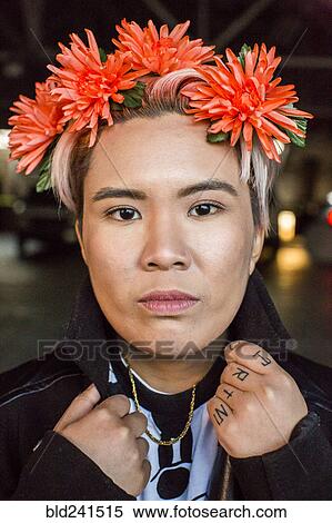 Portrait of serious androgynous Asian woman with flowers in hair View Large Photo Image Stock Photography - Portrait of serious androgynous Asian woman with flowers in hair. Fotosearch