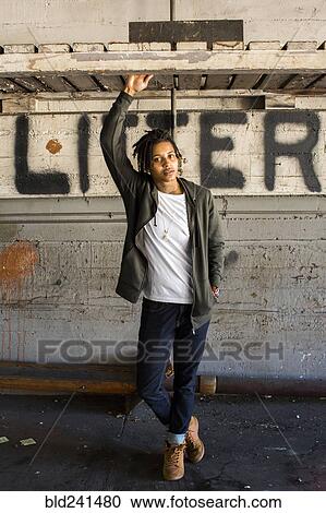 Stock Image - Portrait of serious androgynous Mixed Race woman. Fotosearch