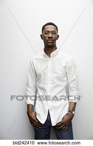 Stock Image - Portrait of serious Black man wearing eyeglasses. Fotosearch