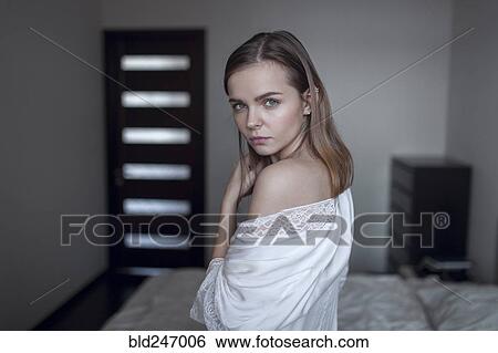 Stock Photograph - Portrait of serious Caucasian woman in bedroom. Fotosearch
