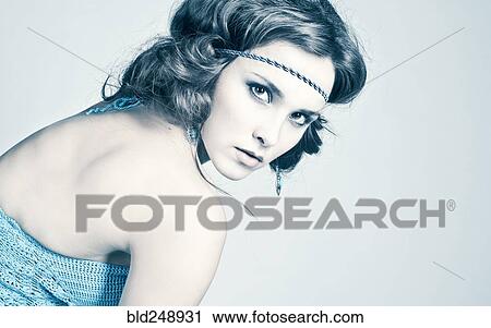Stock Image - Portrait of serious Caucasian woman wearing headband. Fotosearch
