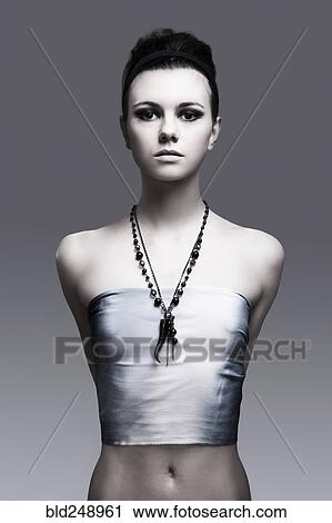 Stock Image - Portrait of serious Caucasian woman wearing necklace. Fotosearch