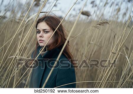 Portrait of serious Caucasian woman standing in field View Large Photo Image Stock Image - Portrait of serious Caucasian woman standing in field. Fotosearch