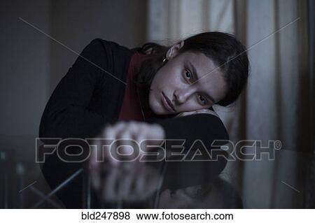 Portrait of serious Caucasian woman leaning face on arm at table View Large Photo Image Stock Photo - Portrait of serious Caucasian woman leaning face on arm at table. Fotosearch