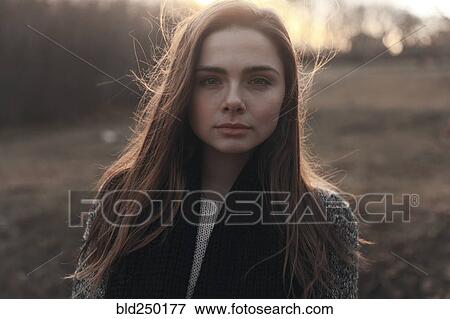 Portrait of serious Caucasian woman with hair blowing in wind View Large Photo Image Stock Photo - Portrait of serious Caucasian woman with hair blowing in wind. Fotosearch