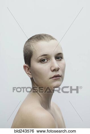Stock Photograph - Portrait of serious Caucasian woman with shaved-head. Fotosearch