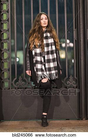 Stock Photograph - Portrait of serious Caucasian woman leaning on gate. Fotosearch