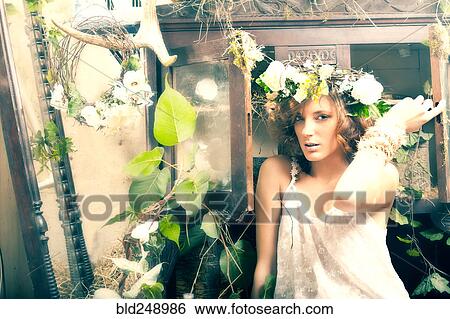 Stock Photograph - Portrait of serious Caucasian woman sitting in garden. Fotosearch