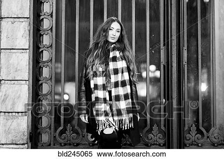 Portrait of serious Caucasian woman standing near gate View Large Photo Image Stock Photography - Portrait of serious Caucasian woman standing near gate. Fotosearch