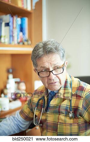 Stock Image - Portrait of serious Hispanic doctor. Fotosearch