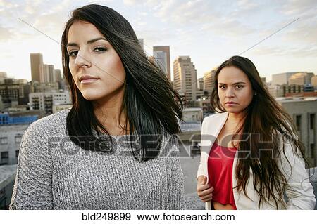 Portrait of serious Hispanic women on urban rooftop at sunset View Large Photo Image Stock Photo - Portrait of serious Hispanic women on urban rooftop at sunset. Fotosearch