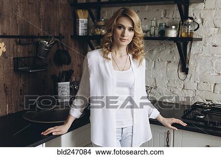 Portrait of serious Middle Eastern woman standing in domestic kitchen View Large Photo Image Picture - Portrait of serious Middle Eastern woman standing in domestic kitchen. Fotosearch