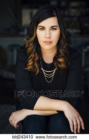 Stock Image - Portrait of serious Mixed Race woman. Fotosearch
