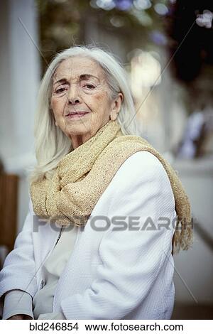 Picture - Portrait of serious older Caucasian woman wearing scarf. Fotosearch