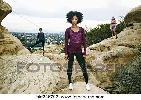 Stock Photo - Portrait of serious women posing on rock formation. Fotosearch
