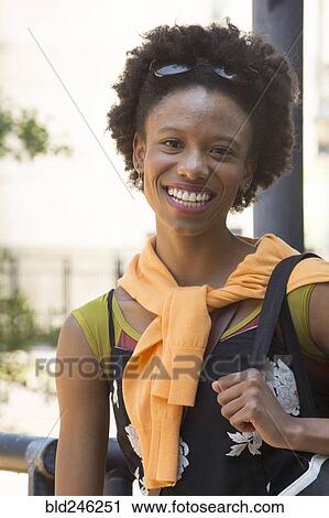 Portrait of smiling African American woman carrying purse View Large Photo Image Stock Image - Portrait of smiling African American woman carrying purse. Fotosearch