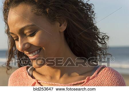 Portrait of smiling African American woman at beach View Large Photo Image Stock Photo - Portrait of smiling African American woman at beach. Fotosearch