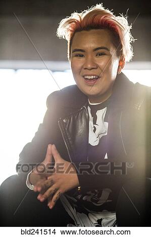 Picture - Portrait of smiling androgynous Asian woman. Fotosearch