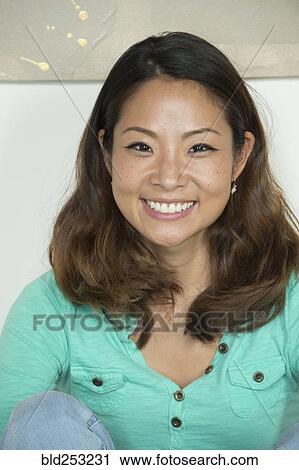 Portrait of smiling Asian woman View Large Photo Image Stock Image - Portrait of smiling Asian woman. Fotosearch