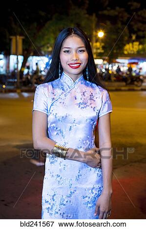 Stock Photo - Portrait of smiling Asian woman wearing traditional clothing. Fotosearch