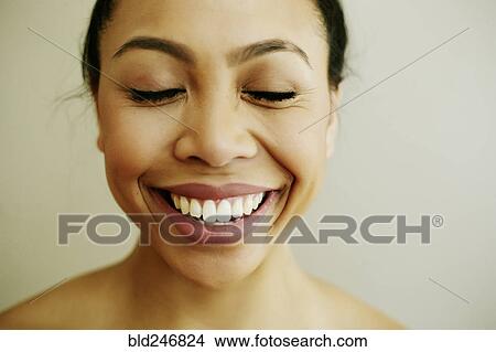 Picture - Portrait of smiling Asian woman with eyes closed. Fotosearch