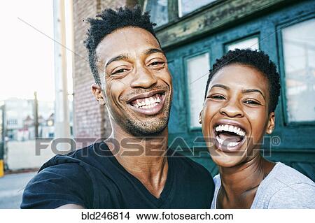 Portrait of smiling Black couple in city View Large Photo Image Picture - Portrait of smiling Black couple in city. Fotosearch