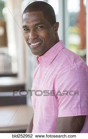 Stock Image - Portrait of smiling Black man. Fotosearch