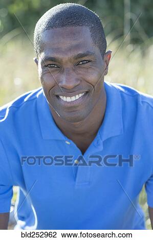 Stock Image - Portrait of smiling Black man. Fotosearch