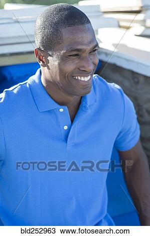 Stock Image - Portrait of smiling Black man. Fotosearch