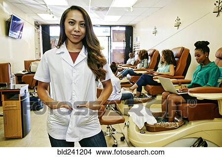 Portrait of smiling business owner in nail salon View Large Photo Image Picture - Portrait of smiling business owner in nail salon. Fotosearch