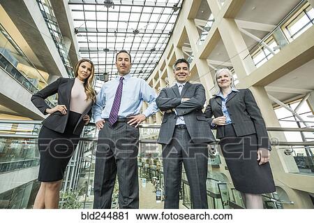 Portrait of smiling business people in lobby View Large Photo Image Stock Image - Portrait of smiling business people in lobby. Fotosearch