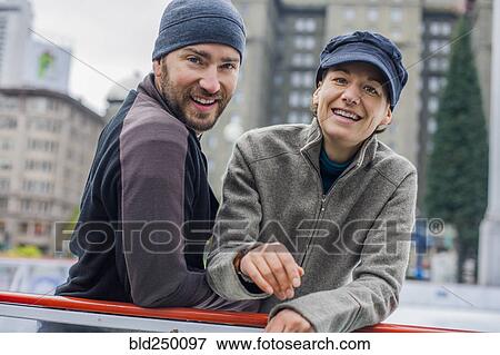 Stock Photo - Portrait of smiling Caucasian couple at ice skating rink. Fotosearch