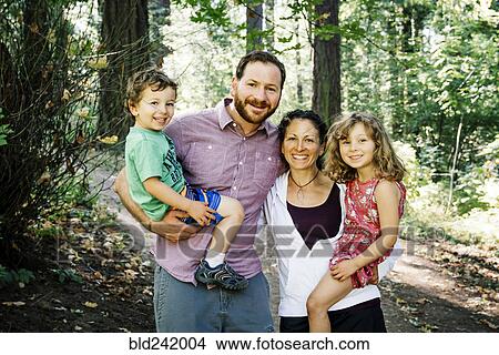 Portrait of smiling Caucasian family in park View Large Photo Image Picture - Portrait of smiling Caucasian family in park. Fotosearch