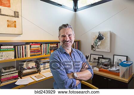 Portrait of smiling Caucasian man in home office View Large Photo Image Stock Photo - Portrait of smiling Caucasian man in home office. Fotosearch