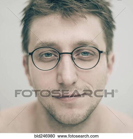 Stock Image - Portrait of smiling Caucasian man wearing eyeglasses. Fotosearch