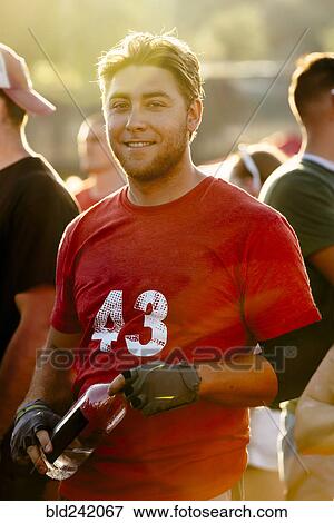 Stock Photo - Portrait of smiling Caucasian man holding water bottle. Fotosearch
