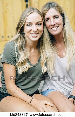 Stock Photo - Portrait of smiling Caucasian mother and daughter. Fotosearch