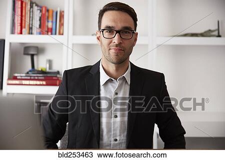 Portrait of smiling Caucasian businessman in office View Large Photo Image Stock Image - Portrait of smiling Caucasian businessman in office. Fotosearch