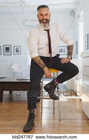Portrait of smiling Caucasian businessman with tattoos View Large Photo Image Stock Photo - Portrait of smiling Caucasian businessman with tattoos. Fotosearch