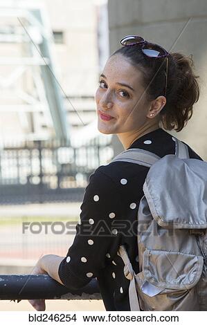 Picture - Portrait of smiling Caucasian teenage girl carrying backpack. Fotosearch