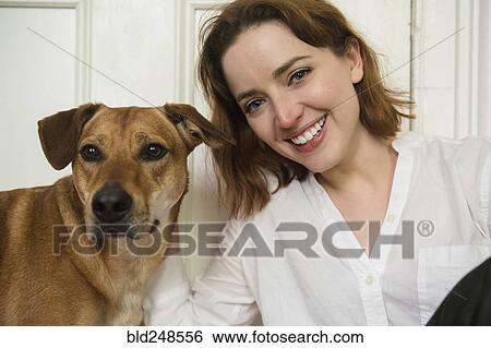 Portrait of smiling Caucasian woman and dog View Large Photo Image Stock Photograph - Portrait of smiling Caucasian woman and dog. Fotosearch